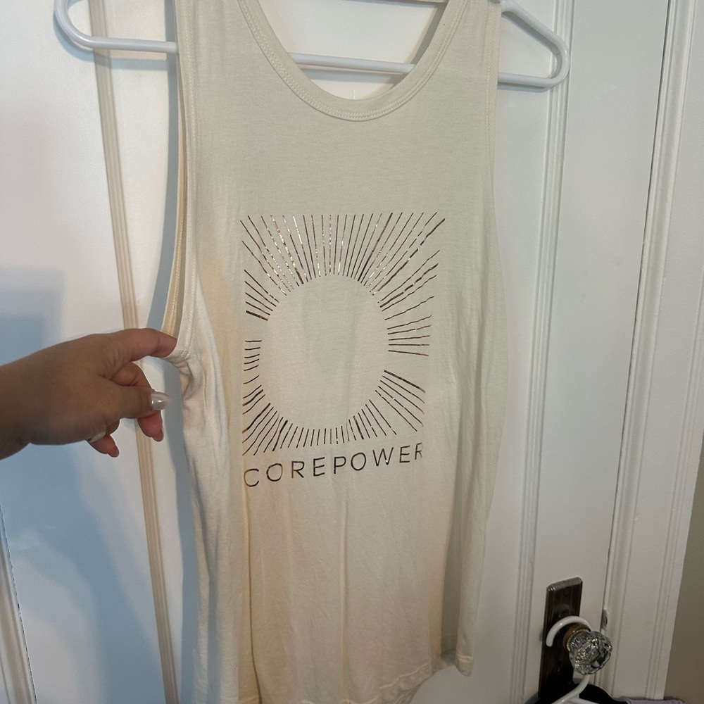 Like new ivory CorePower open back detail tank top with gold foil sun print